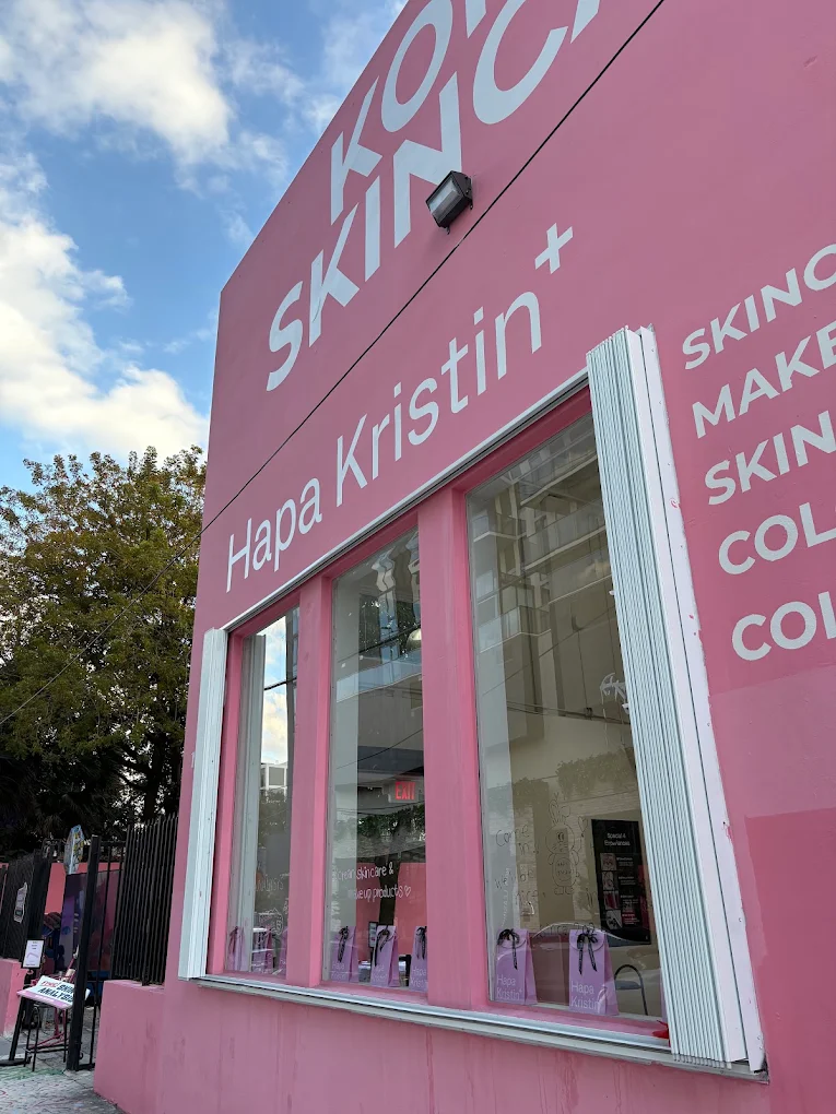 Hapa Kristen Wynwood storefront — pink facade with skincare and makeup signage at the grand opening