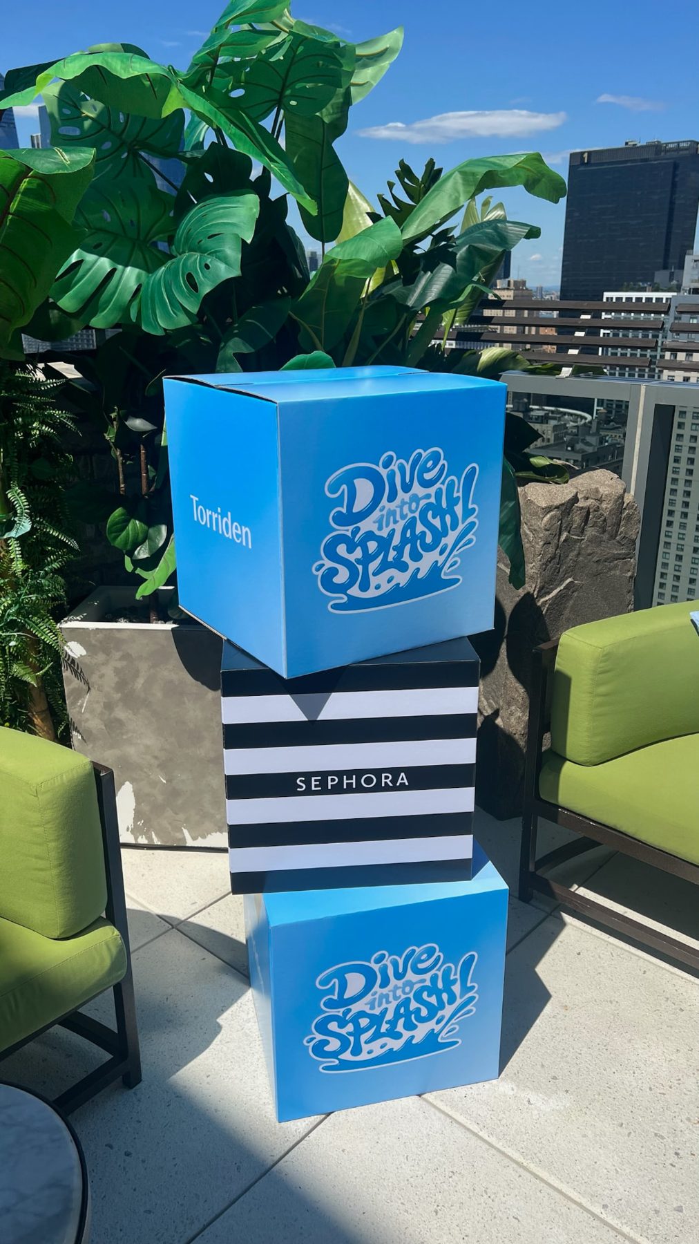 Torriden x Sephora branded boxes stacked at the Dive into Splash pool party activation in New York