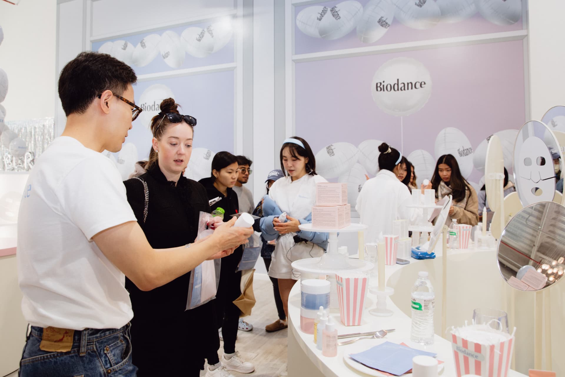 Guests testing Biodance products at the retail consultation table inside the pop-up