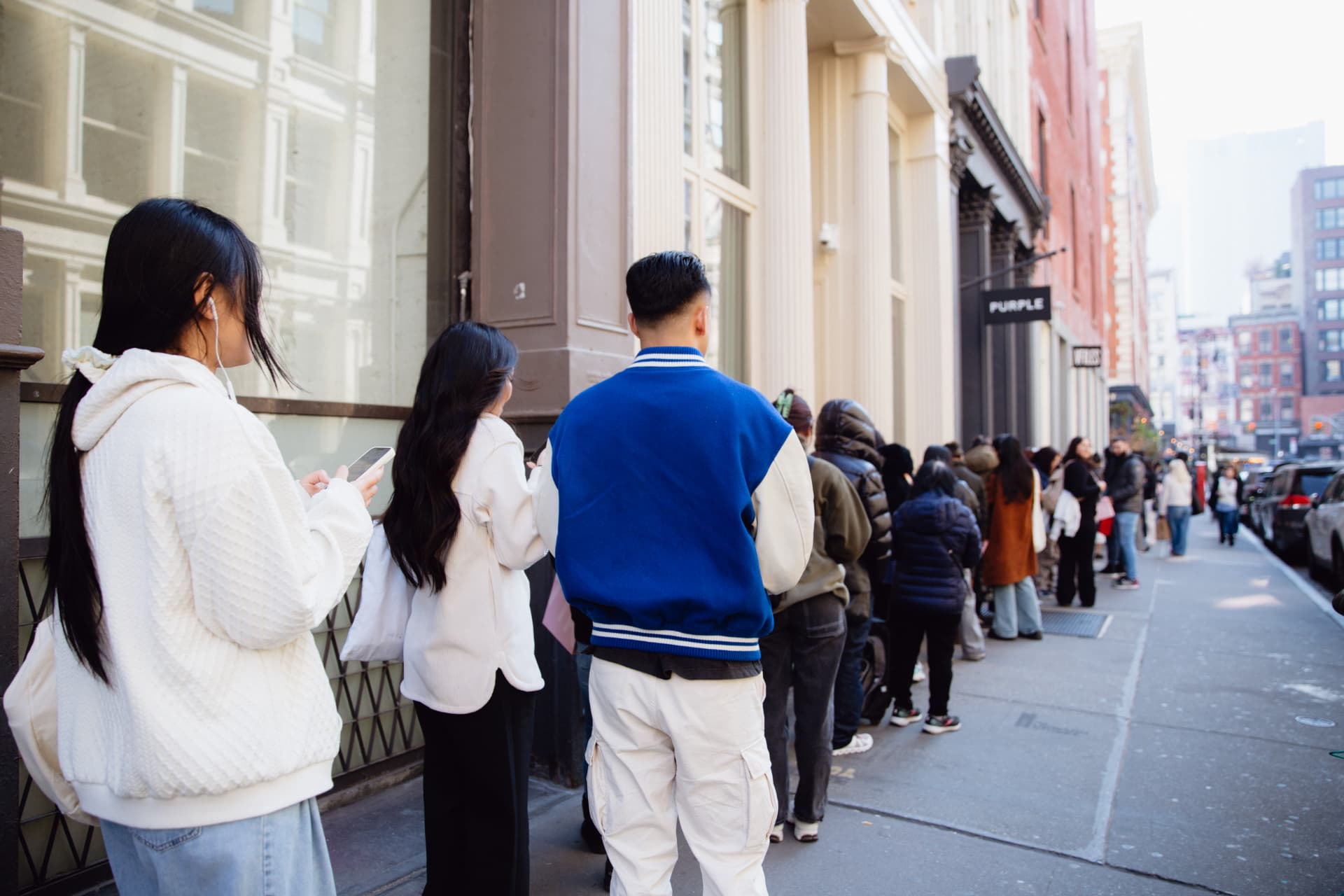 Attendees waiting in line on their phones outside the Biodance New York pop-up