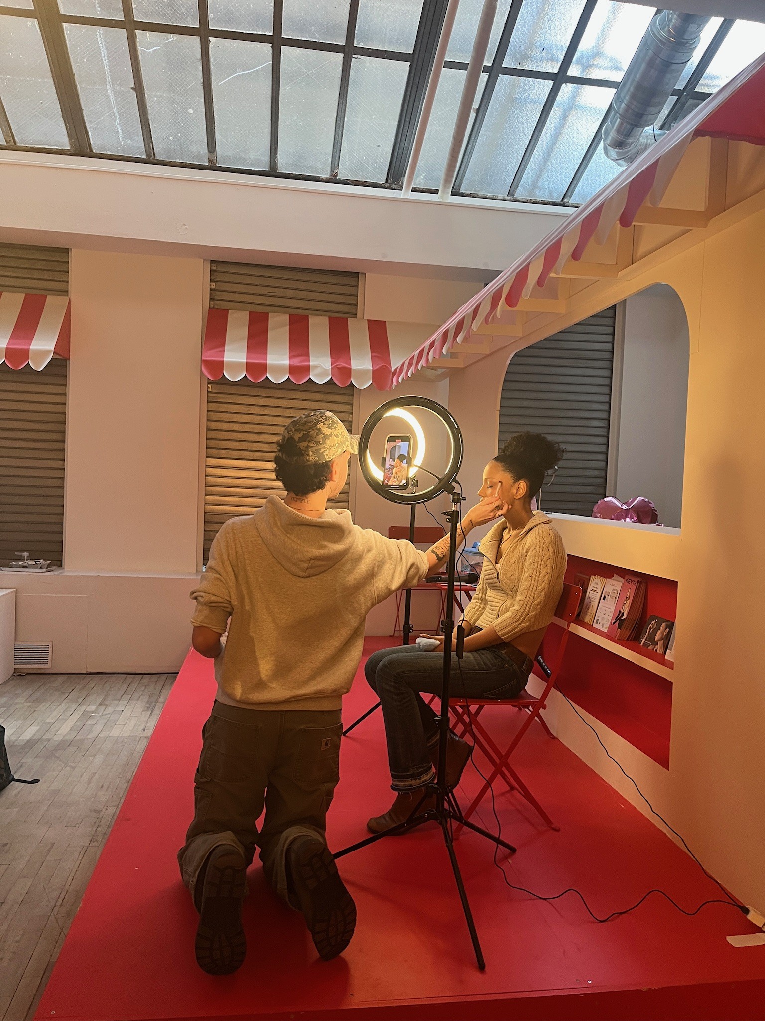 Wide view of the Beauty Bakery stage with creator, host, and ring-light setup